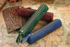 Brown leather cylinder pen case for desk storage