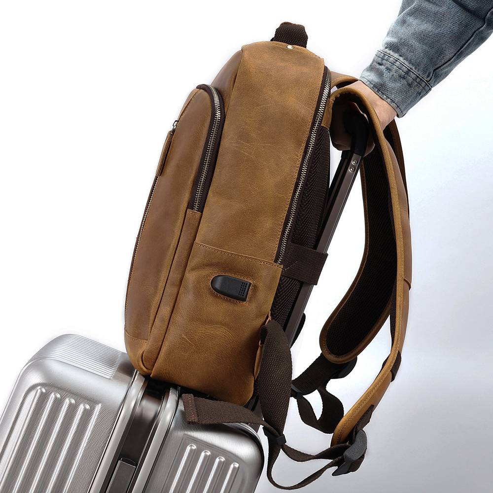 Brown men's leather backpack, USB charging port detail