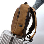 Brown men's leather backpack, USB charging port detail