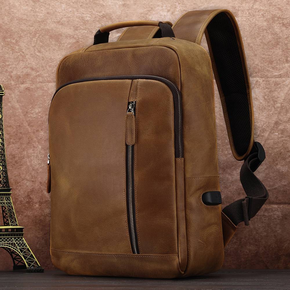 Brown men's leather backpack, front pocket detail