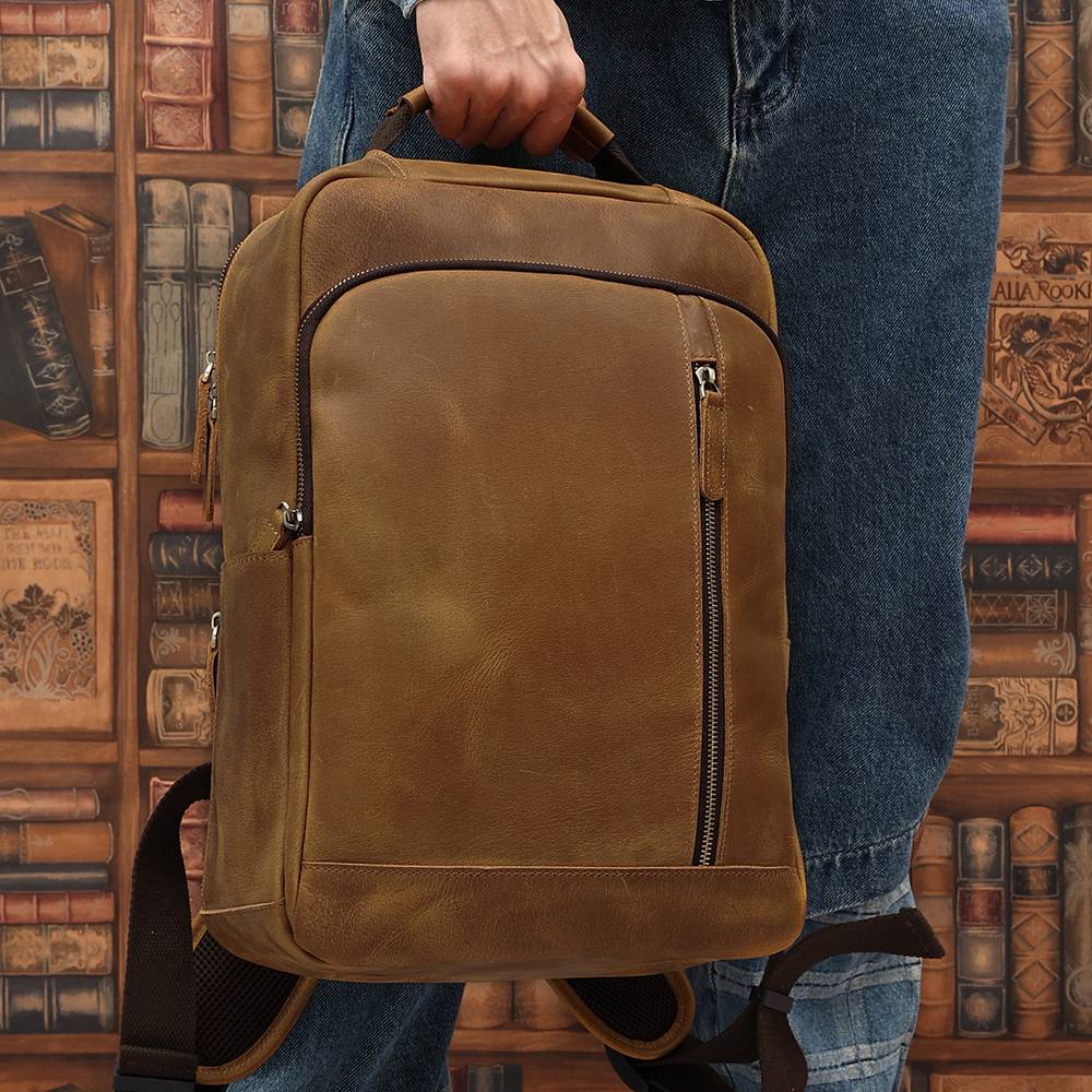 Brown men's leather backpack, handle detail