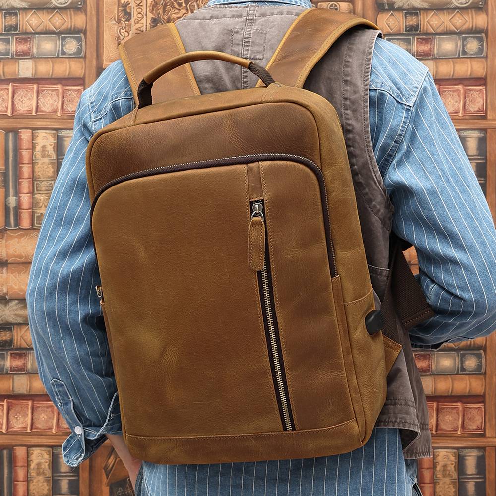 Brown men's leather backpack, strap detail