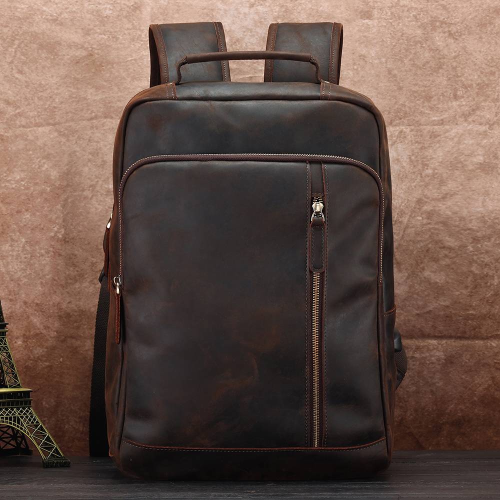 Dark brown men's leather backpack, top handle detail