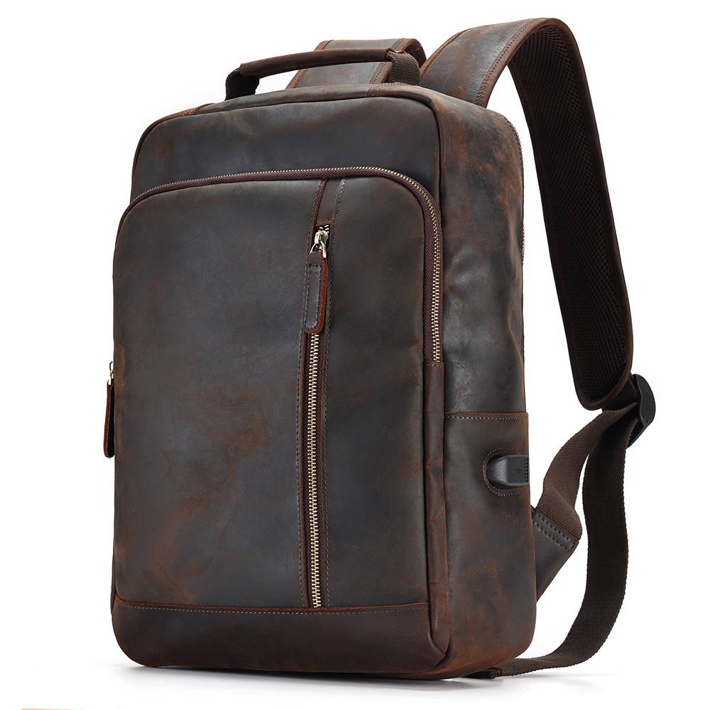 Man wearing the leather backpack on a coastal trail