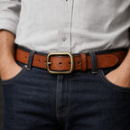 Brown full-grain men's leather belt worn with jeans