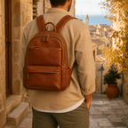 Man wearing the brown leather bookbag in a coastal town