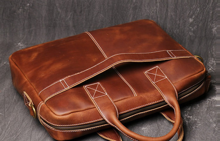 Brown men's briefcase, back view with trolley strap