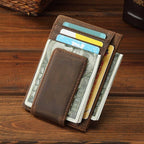 Man holding the dark brown money clip card holder
