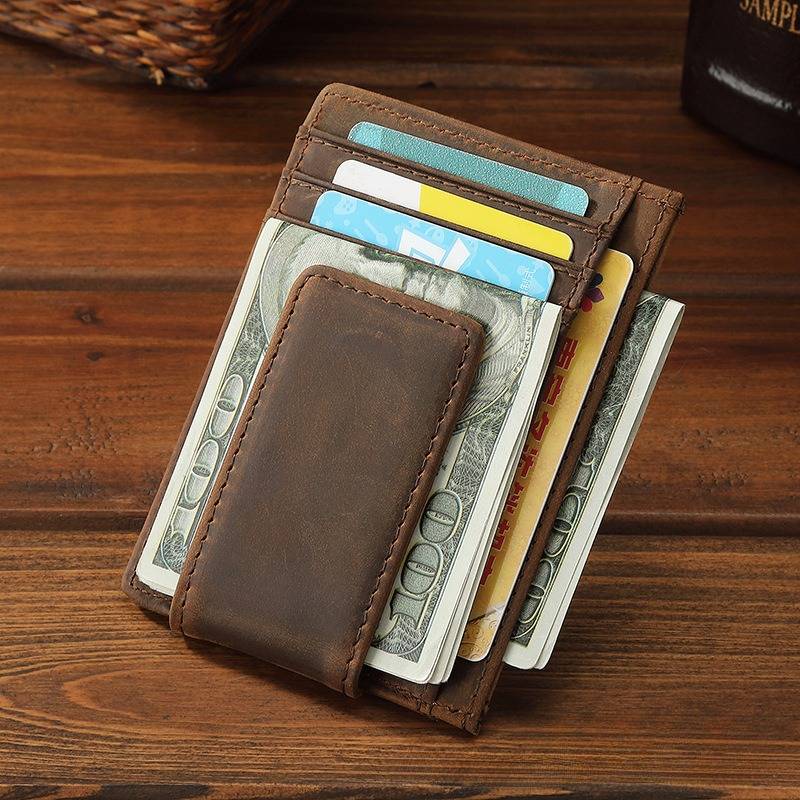 Man holding the dark brown money clip card holder