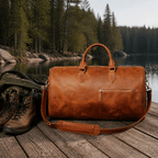 Brown men's carry-on bag by a mountain lake