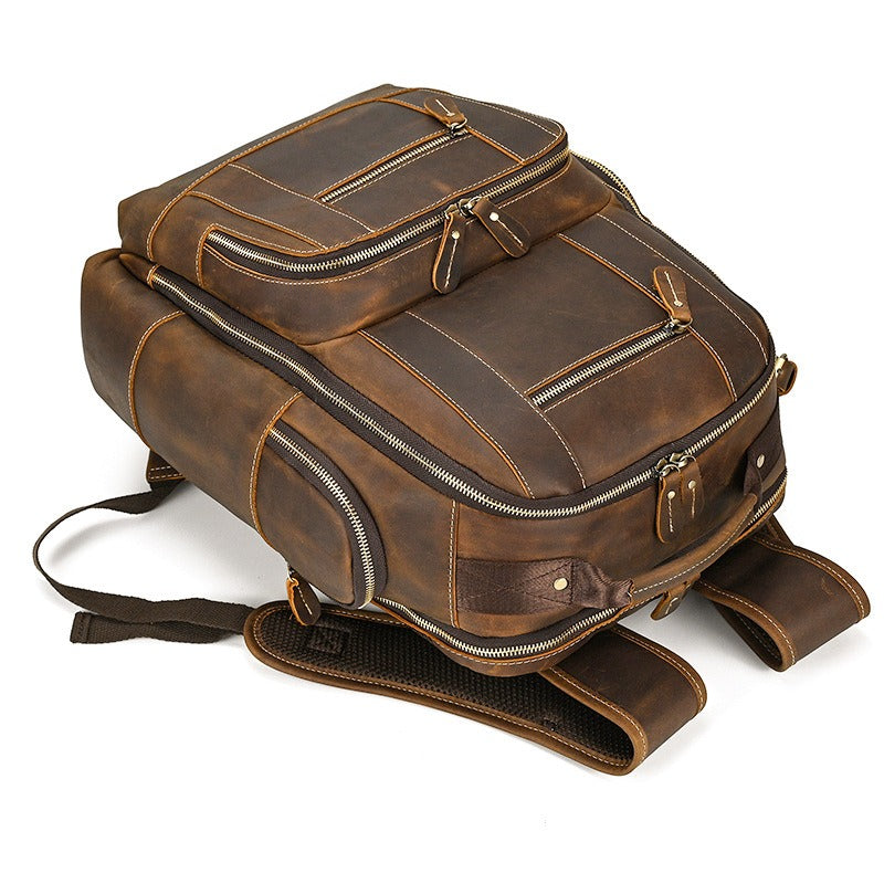 Brown men's college backpack, handle detail