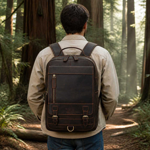 Man wearing the leather commuter backpack in a forest
