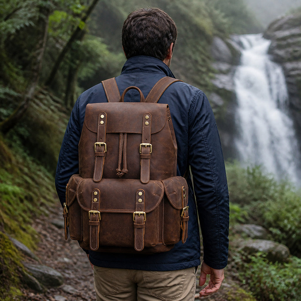 Man wearing the leather knapsack near a waterfall