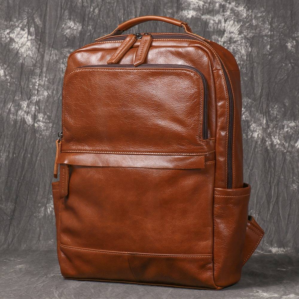 Brown men's laptop backpack, strap detail