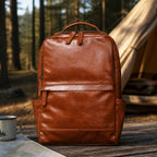 Brown men's laptop backpack at a campsite