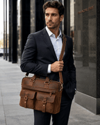 Man carrying the brown leather laptop bag, front