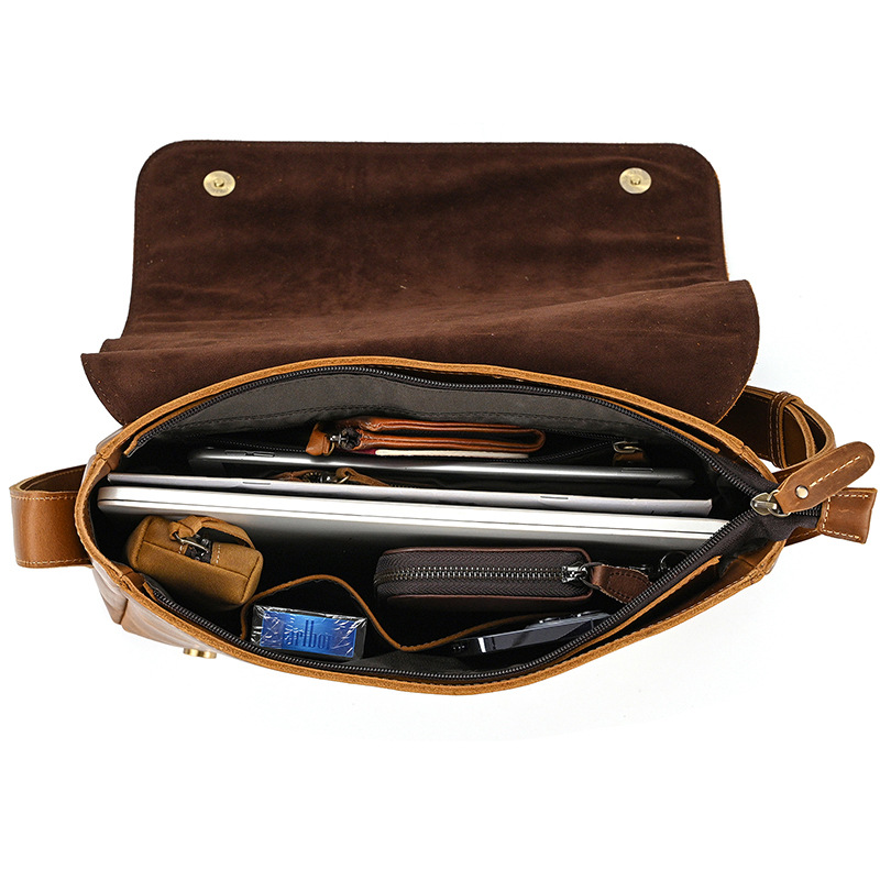 Brown men's messenger bag, interior packed with laptop and items