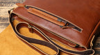 Brown men's messenger bag, front pocket slot detail