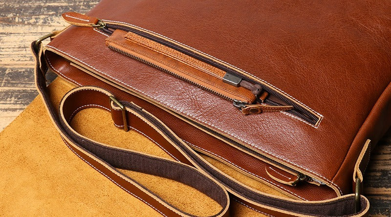 Brown men's messenger bag, front pocket slot detail