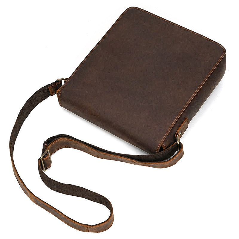 Dark brown men's messenger bag, flat lay