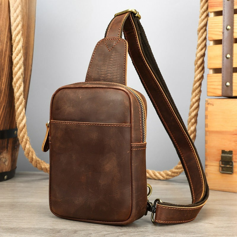 Brown men's one-shoulder bag, earphone cable hole and clasp detail