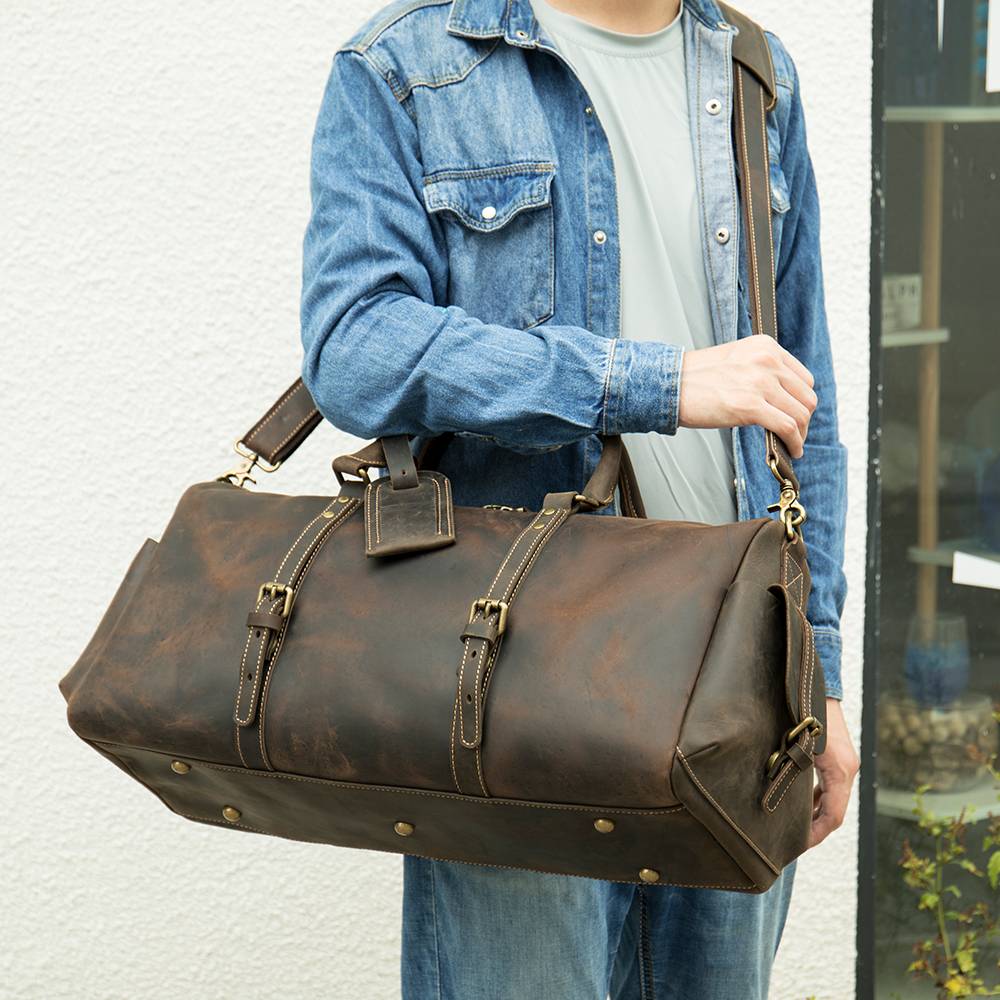 Brown-black men's overnight bag, strap detail