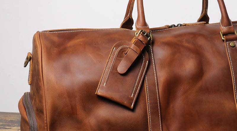 Brown men's oversized duffle bag, handle detail