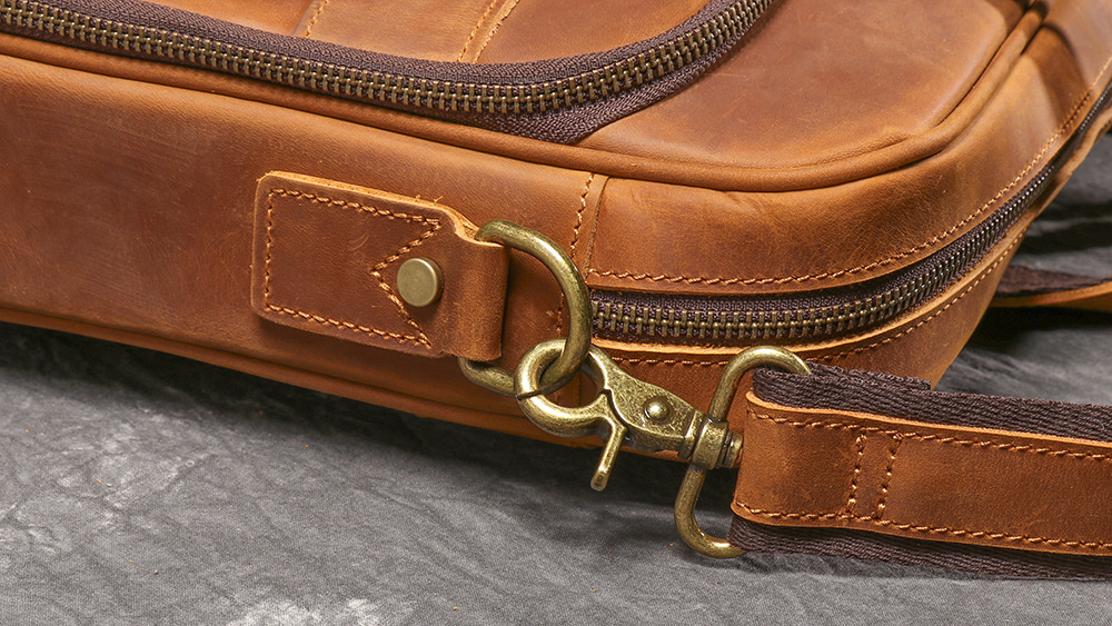 Brown men's satchel, back view with trolley strap