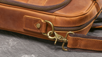 Brown men's satchel, back view with trolley strap