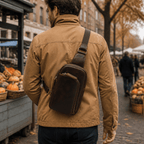 Man wearing the leather sling chest bag at an autumn market