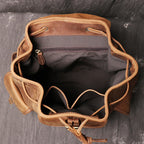 Brown men's travel backpack, drawstring detail