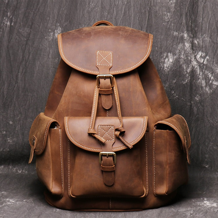 Brown men's travel backpack, front pocket detail