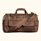 Man carrying the brown leather weekender bag at the airport