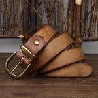 Yellow brown men's leather belt coiled flat lay