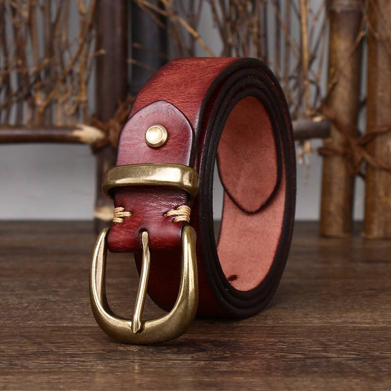 Red men's leather belt buckle close-up